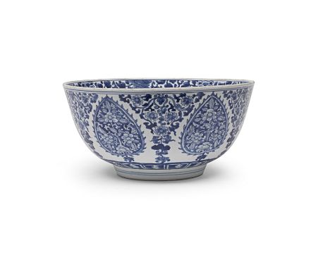 A LARGE BLUE AND WHITE 'FLORAL' BOWLKangxiSturdily potted with deep rounded sides rising from a short, inward-tapering foot, 