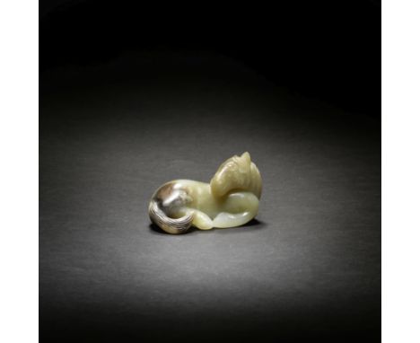 A PALE GREEN AND RUSSET JADE CARVING OF A HORSE17th/18th centurySmoothly carved recumbent with legs tucked beneath the large 