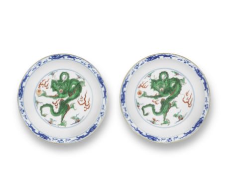 A VERY RARE PAIR OF IMPERIAL DOUCAI 'DRAGON' DISHESYongzheng six-character marks and of the periodThe delicately potted dishe