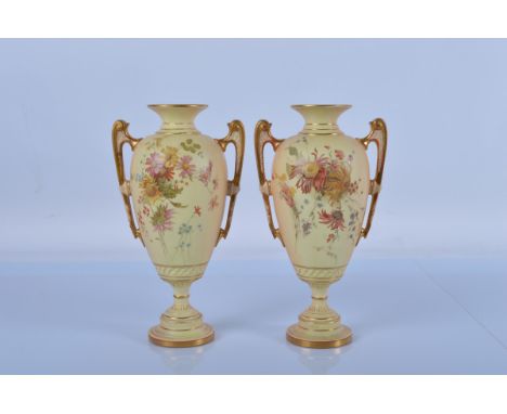 A pair of Royal Worcester blush ivory twin handled vases, Rd No. 161524, shape no. 1481. 24.5 cm tall