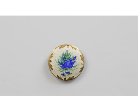 A silver and enamel floral circular brooch, with blue iris decoration, 3.8cm together with a continental early 20th Century w