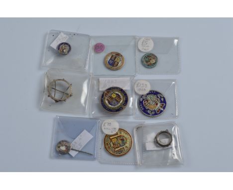 Seven Georgian and Victorian enamel coins, including some with pin and brooch fittings and button mounts, together with two e