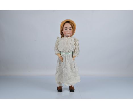 A Max Handwerck 297 child doll, brown sleeping eyes, blonde hair wig, jointed composition body and printed muslin dress, 22 1