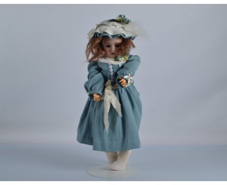 A Simon and Halbig for Heinrich Handwerck child doll, with blue sleeping eyes, pierced ears, brown mohair wig, jointed compos