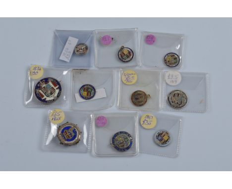 Ten Georgian and Victorian enamel coins, including some with brooch mountings and suspension loops etc