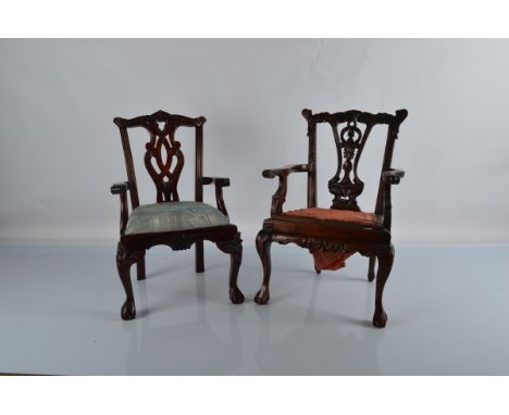 A Chippendale style reproduction doll armchair, with carved back rail and pierced ornate back splat, with slip in green uphol