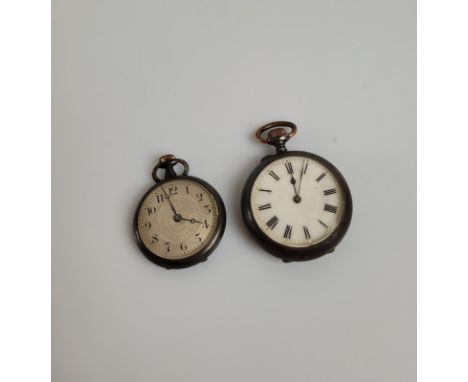 Two lady's gun metal open faced fob watches, the larger with white face, black roman numerals, together with a silvered engin