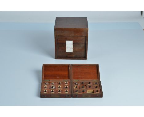 Two Edwardian specimen boxes containing pocket watch parts, together with a small box with a sliding roller door, 16.5cm tall