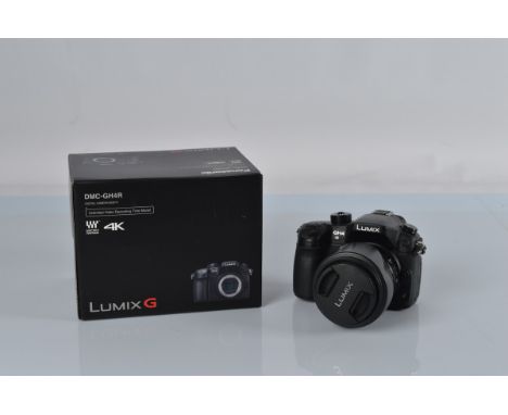 Panasonic Lumix DMC-GH4 4K digital camera, with a Lumix G Vario 1:3.5-5.6 /14-140 lens, with box.