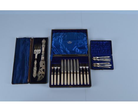A silver plated nutcracker set, together with a fish knife and fork set and a six person knife and fork set, all boxed (3)