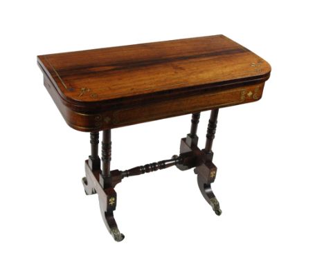 A fine quality Regency rosewood fold-over Card Table, the top with brass inlay above a conforming frieze supported by double 