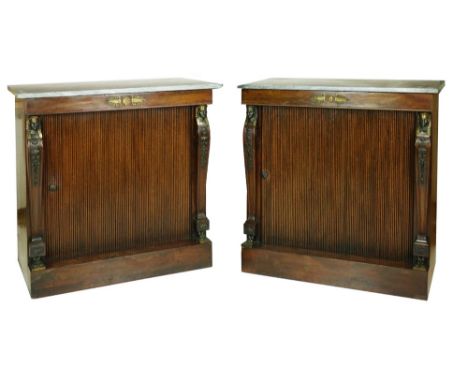 A very fine pair of Regency mahogany Side Cabinets, applied with gilt metal mounts, each with an associated grey marble top a