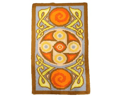 A Celtic Revival wool Rug, with typical Celtic design, the blue ground central panel with motifs inside a slim brown border, 