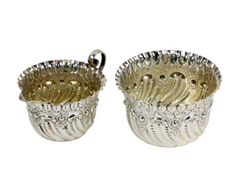 An attractive small Irish Georgian style Sugar Bowl and Cream Jug, with floral repoussé work and fanned edge, Gibson &amp; Co