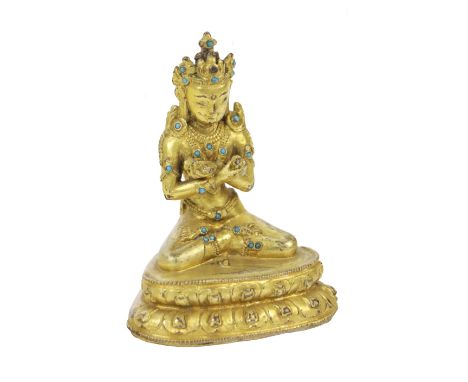 A rare early Vajradhara Buddha,&nbsp;Tibet possibly 17th / 18th Century, gilt metal set with turquoise stones, in typical sea