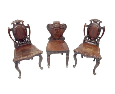 A pair of Victorian mahogany shield back Hall Chairs,&nbsp;with pieced and decorated backs on shaped solid seats on front cab