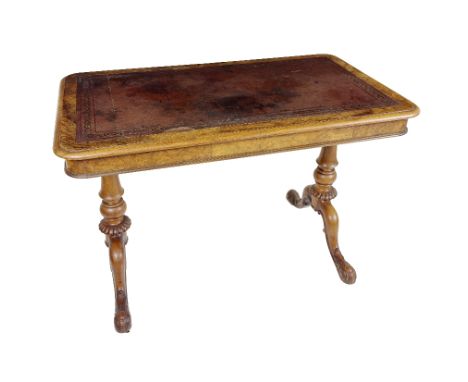 A Victorian walnut Ladies Writing Table, by Gillows, with tooled leather inset top, and moulded edge above two frieze drawers