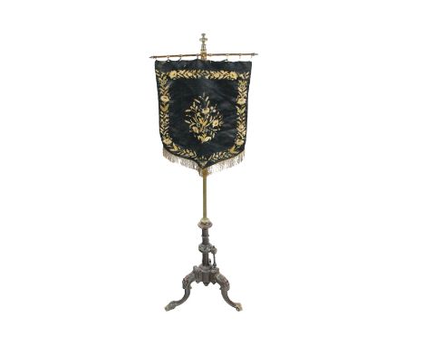 A Victorian Ladies upholstered Fire Screen, decorated with floral garland, brass adjustable upright on a carved triform base,