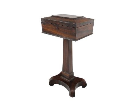 A fine quality 19th Century mahogany Teapoy, the sarcophagus shaped hinged top opening to reveal a fitted interior, on a tape