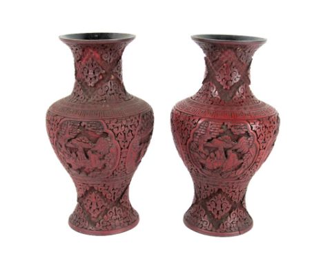 A pair of 19th Century Chinese cinnabar baluster shaped Vases, with landscape and figural panels, the overall decorated in th