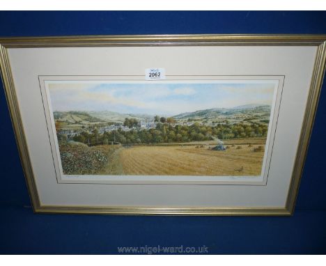 A framed limited edition Print depicting Hay-on-Wye, no. 698/850, signed Peter Hodge lower right