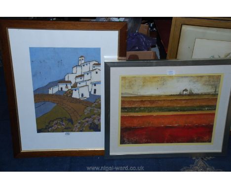 A continental print on fabric of a house by a bridge along with a framed print of a continental house with fields of varying 