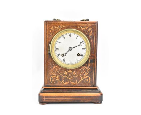 A late 19th century French rosewood mantle clock, the case having a gilt metal handle and with floral scroll marquetry inlaid