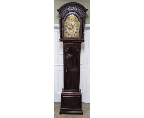 A George III mahogany 8 day longcase clock, having an arched top with floral pierced fretwork, reeded columns flanking the gi