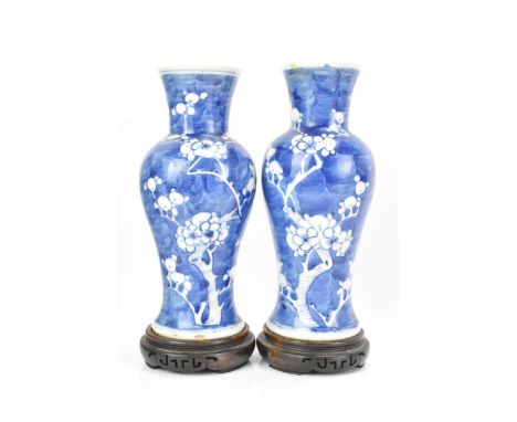 Two Chinese late Qing dynasty blue and white vases, late 19th/early 20th century, each of baluster form, in the Kangxi style 