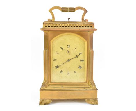 A 19th century English gilt metal repeater goliath carriage clock, the gilt arched top dial engraved with scroll work, Roman 