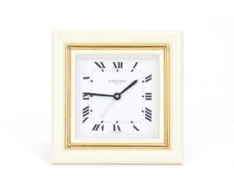 A Cartier travel alarm clock, having a square cream enamel and gilt metal case, the white enamel dial having Roman numerals, 