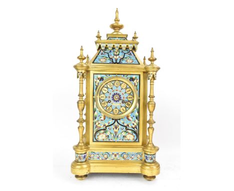 A late 19th century French champleve enamel mantle clock, the case of architectural form with turned finials, four columns, e