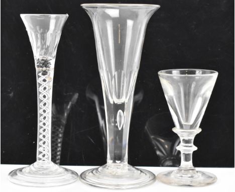 Three glasses to include a George III ale flute 17.8cm high, a George III air twist cordial glass 16.6cm high and an early 19