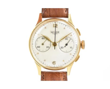 A Heuer ‘Big Eye’ chronograph, manual wind, gents, 18ct gold wristwatch, circa 1950s, model no. 418, the silvered dial having