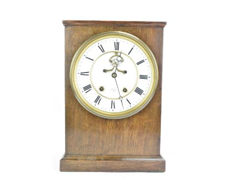 A late 19th century oak cased mantle clock, the white enamel dial having Roman numerals, Breguet style hands, signed 'Bennett