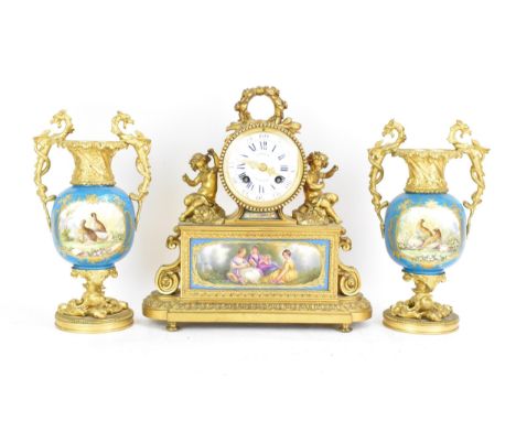 A 19th century French gilt metal clock garniture, the clock having a floral garland finial, the drum clock flanked by two sea