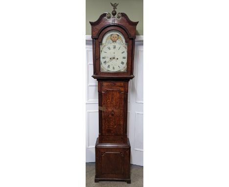 A George III oak 8 day longcase clock, the case having a broken swan neck pediment with a cast eagle finial, the arched top d