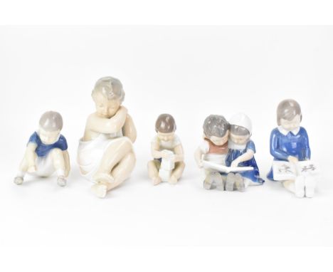 Five Royal Copenhagen porcelain figures of children, to include girl with a picture book. model no. 2247, 12cm high, boy and 