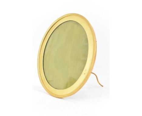 An early 20th century gilt metal oval photograph frame, retailed by Walter Jones, having a reeded frame, felt back and easel 