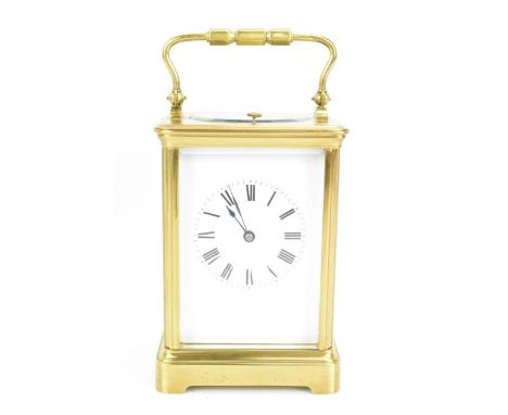 An early 20th century repeating brass cased carriage clock, having a white enamel roman dial, repeater movement with platform