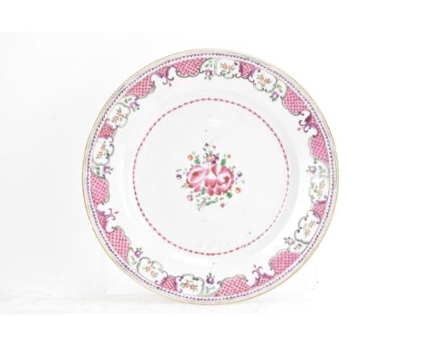 A Chinese 18th century Qianlong famille rose plate, painted with a floral spray to the centre surrounded by a lattice border 