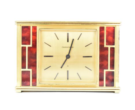 A Jaeger LeCoultre gilt metal table clock, circa 1950s, of rectangular form, the case with red lacquer to the front and sides