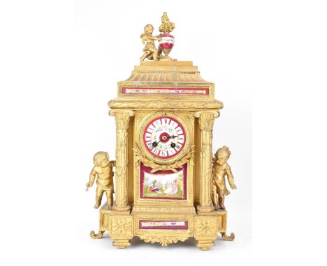 A late 19th century French gilt metal mantle clock, the case of architectural form, mounted with cherubs, inset with Sevres s