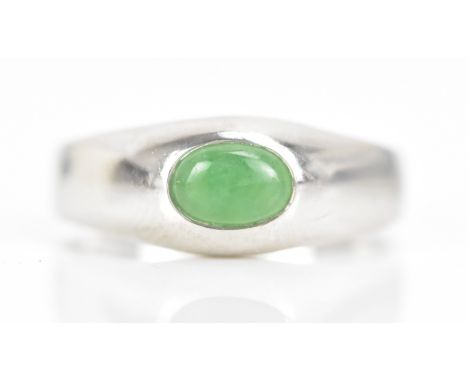 An 18ct white gold jade ring, with a certificate of guarantee stating the jade 1.08cts, stamped 750, ring size T, 6.2 grams