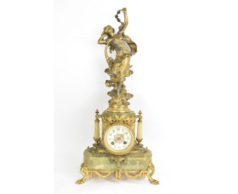 A late 19th century French spelter and onyx mantle clock, mounted with a classical maiden above ribbon garlands, tapering col
