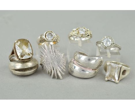 EIGHT RINGS, of varying designs to include paste and cubic zirconia set, cross over design etc, all with marks to indicate si