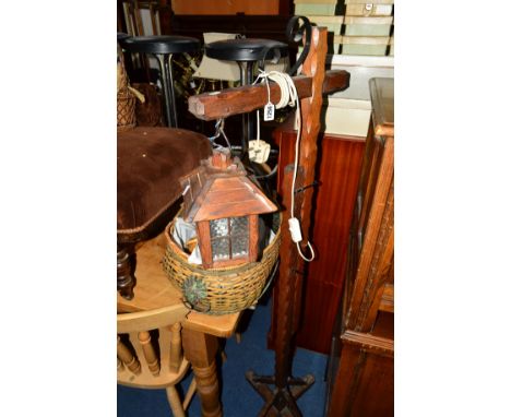 AN OAK FRAMED STANDING LANTERN on an adjustable stand