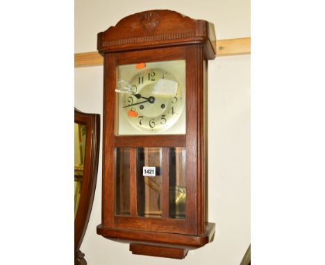 A MID 20TH CENTURY OAK CASED WALL CLOCK (winding key)