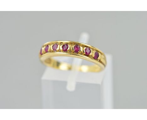 A 9CT GOLD RUBY HALF ETERNITY RING, set with seven circular rubies, hallmark rubbed, ring size M, weight 2.6 grams