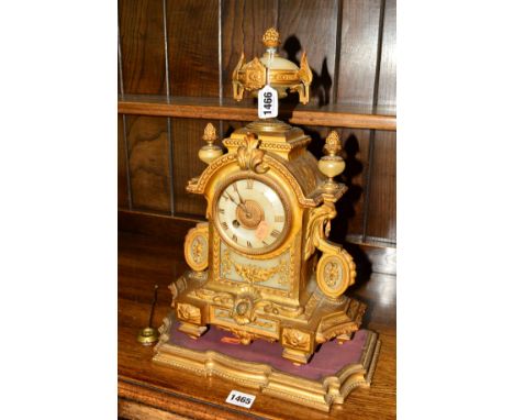 A 19TH CENTURY GILT AND ONYX ORMOLU MANTLE CLOCK, 30 hour movement, Roman numerals, on a separate base, approximate height 42